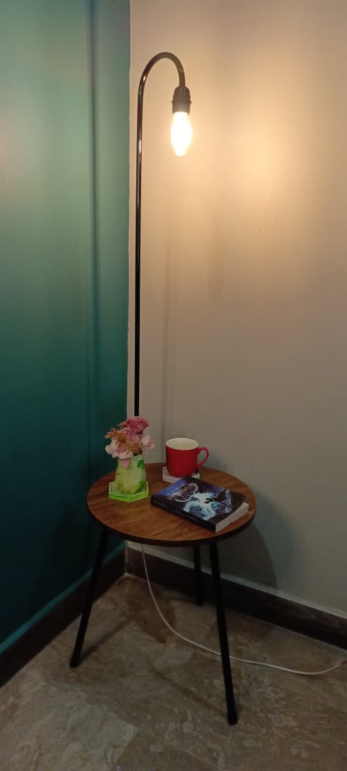 Top angle view of built-in table and lamp showcasing wood grain and design layout