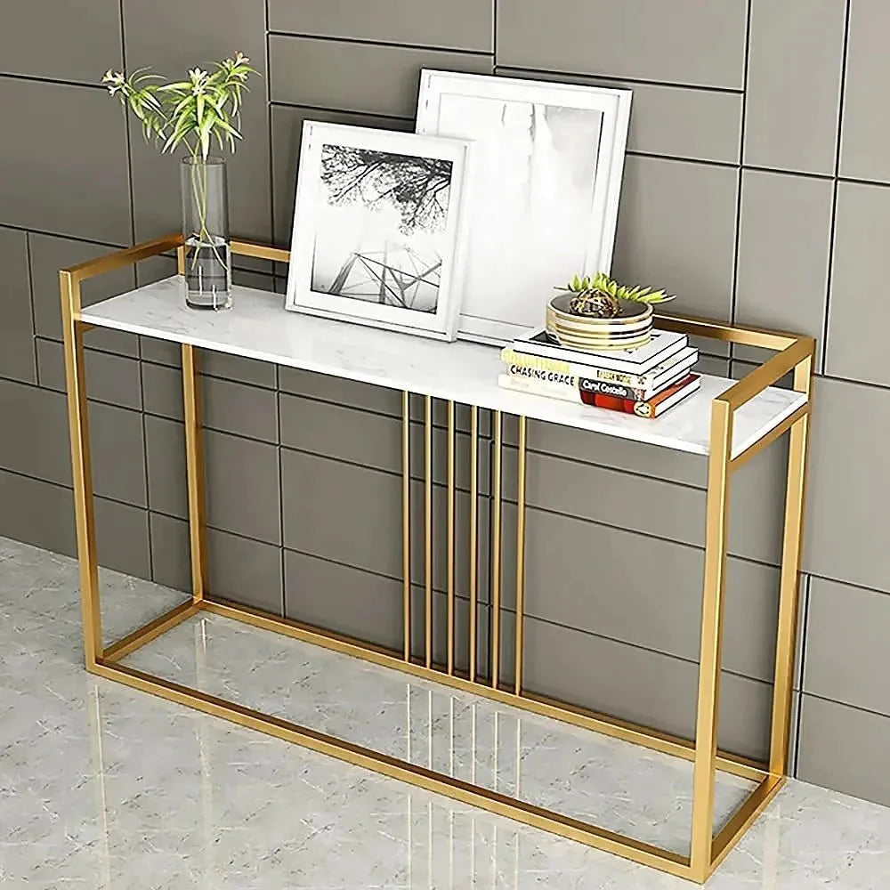 A luxury console table with a pure gold and white color scheme, featuring a metal frame with stowing enamel and an acrylic top, displayed in a room setting with decorative items on top.