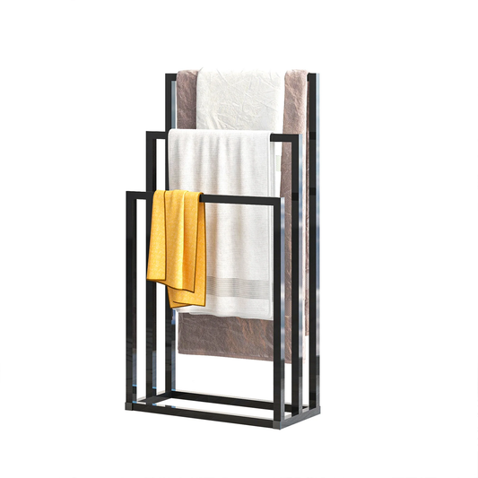 A 3-tier free towel rack with a polished metallic finish. It features a bottom shelf with a towel hanging on it and two upper tiers with no towels.