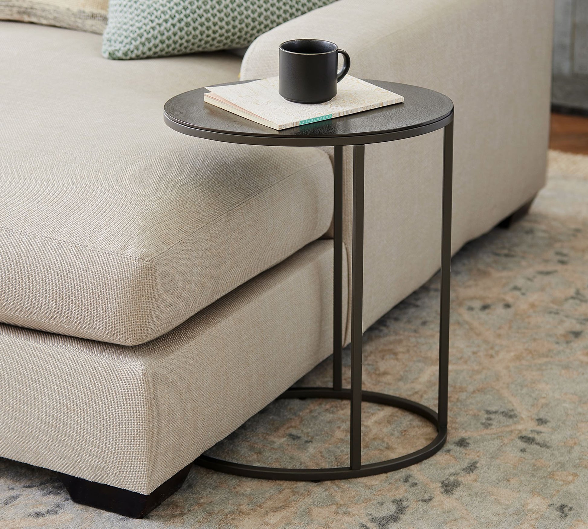 Dukes side table with dark wood top and black frame placed beside a sofa – MetalX
