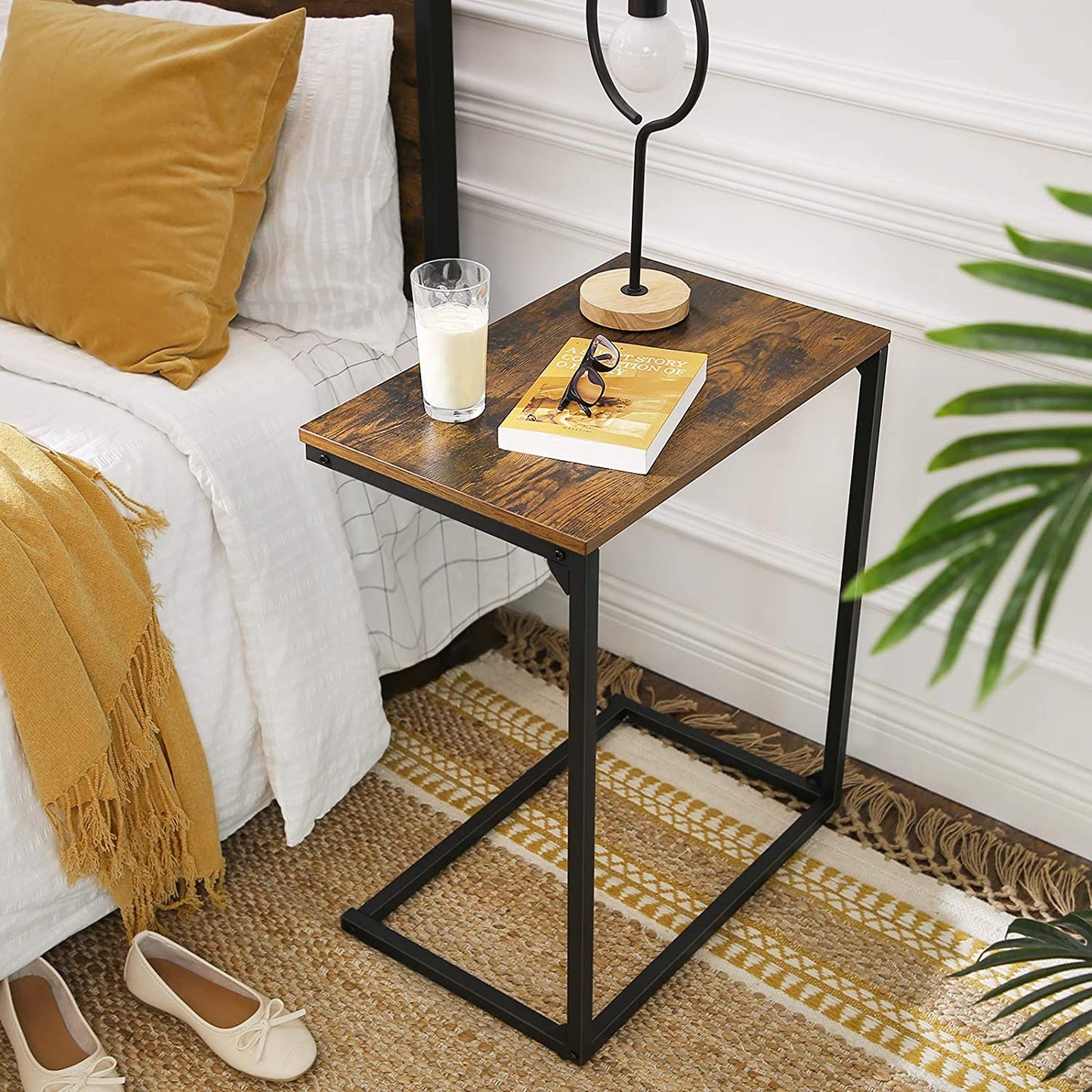 Wooden laptop stand with black steel frame placed beside a bed for daily use – MetalX