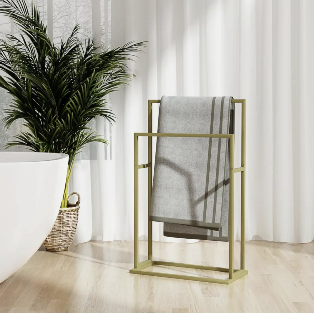 Luxury gold towel hanger by MetalX displayed in a modern bathroom setting