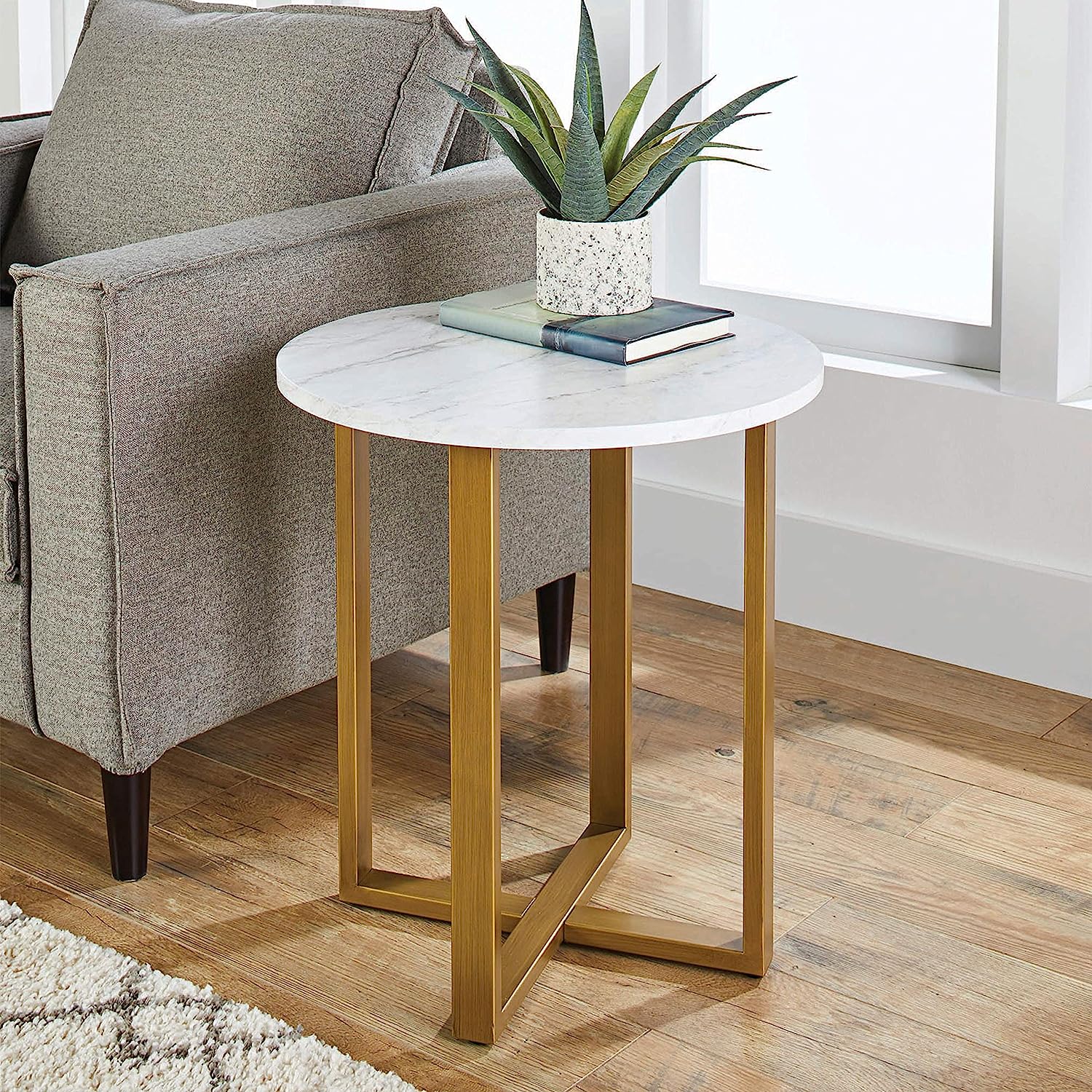 Modern side table with textured marble top and gold frame styled beside a sofa – MetalX