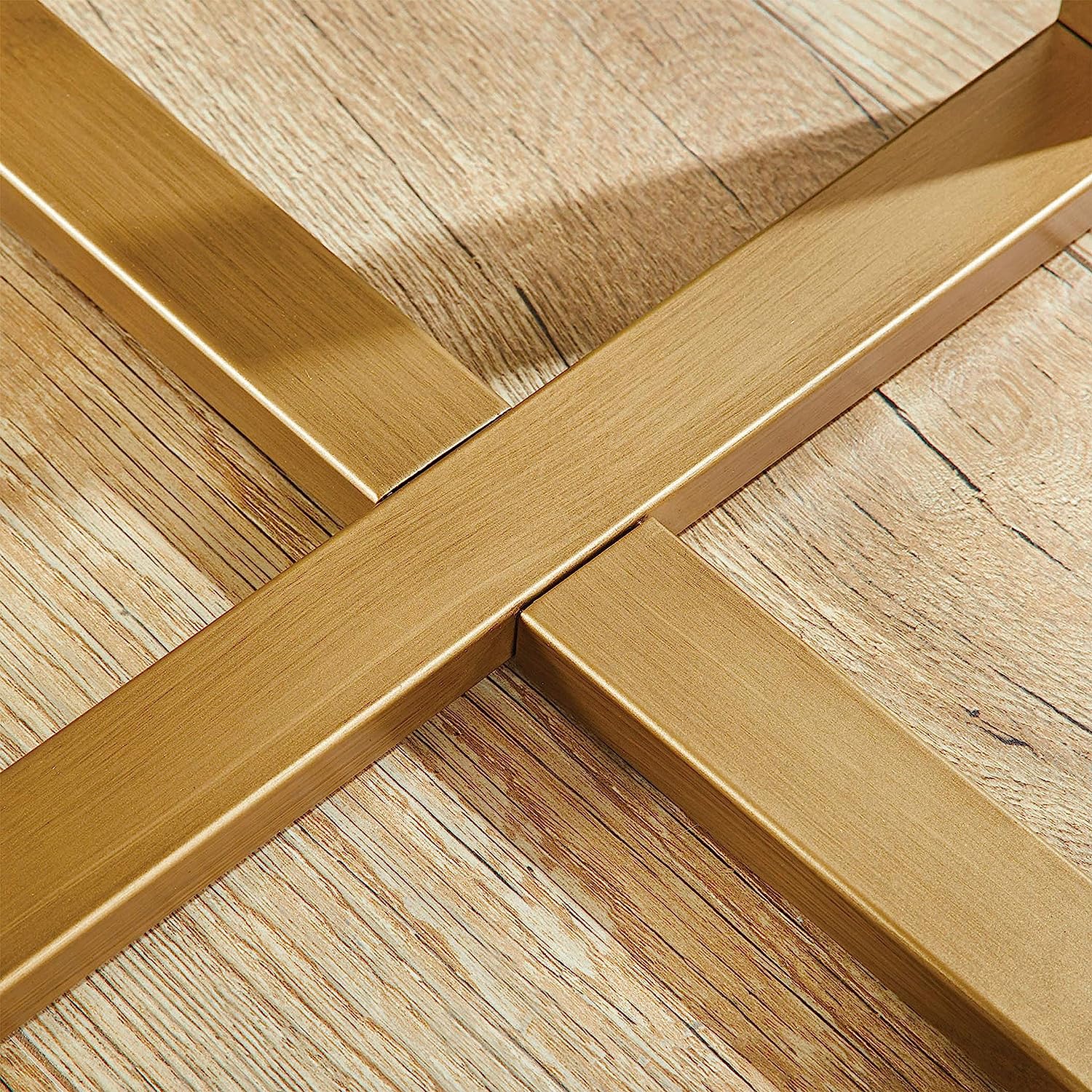 Close-up of gold legs and frame design of marble top side table in real room – MetalX