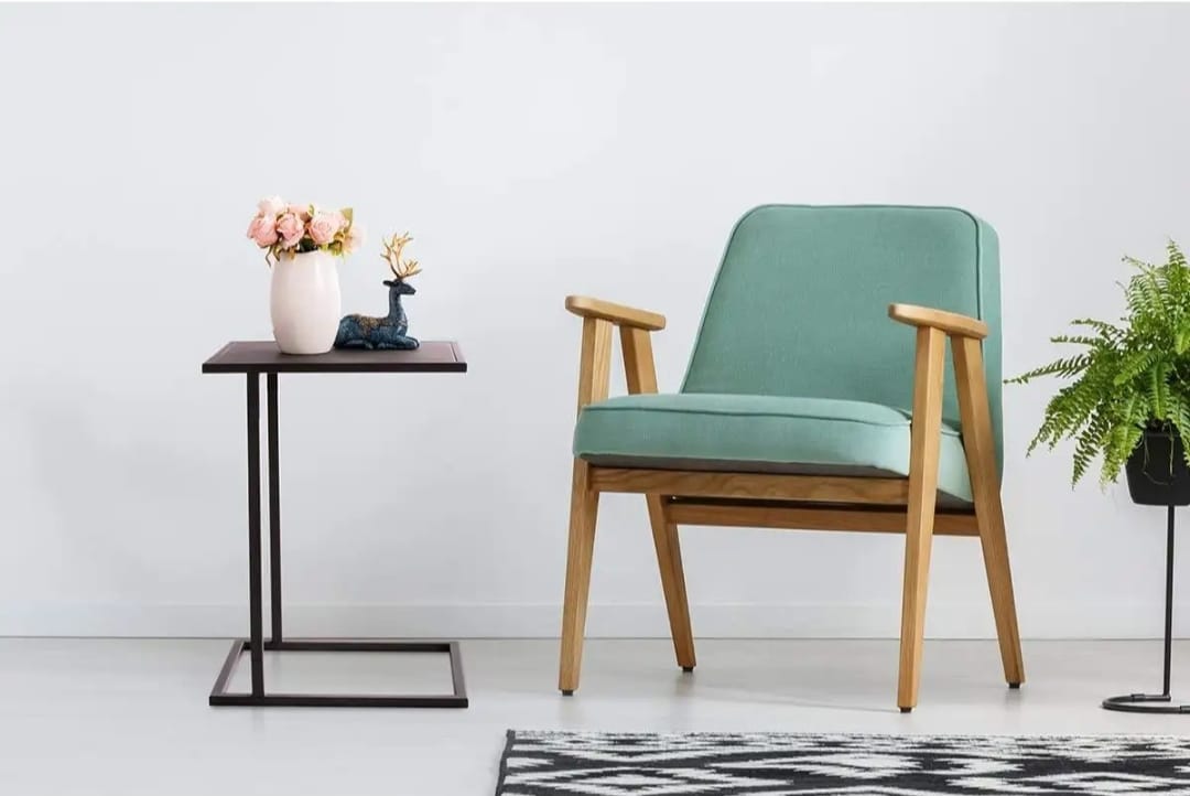 Mini laptop table with walnut top and black frame placed beside a bed for compact work use – MetalX