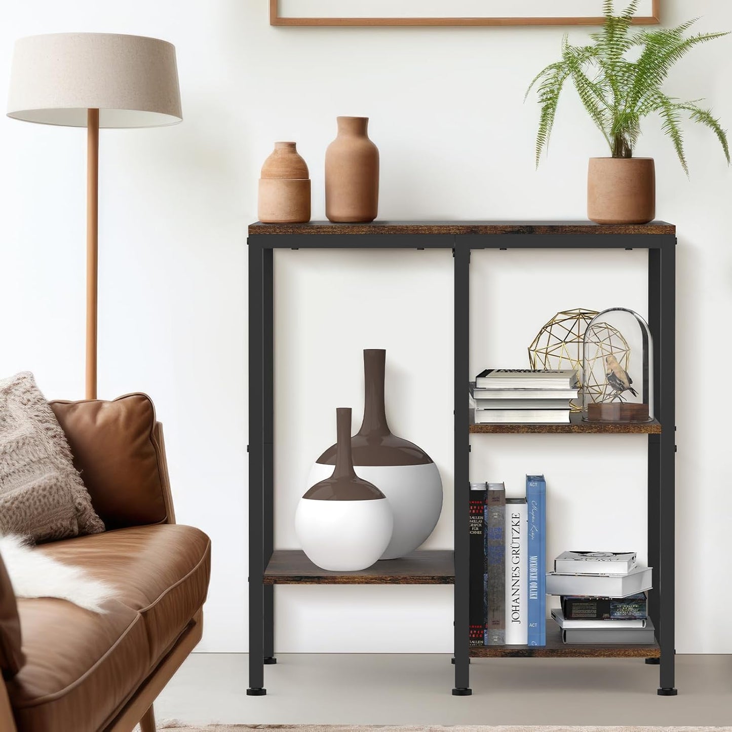 Living room with a sofa, lamp, and decorative shelf with books and vases.