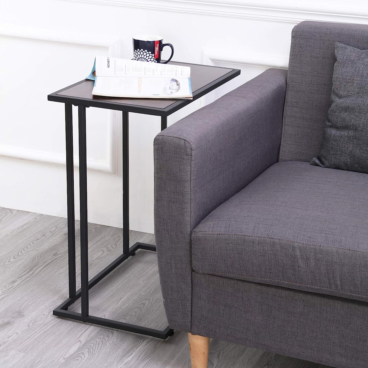 Snack table with walnut wood top and black steel frame in real use beside a sofa – MetalX