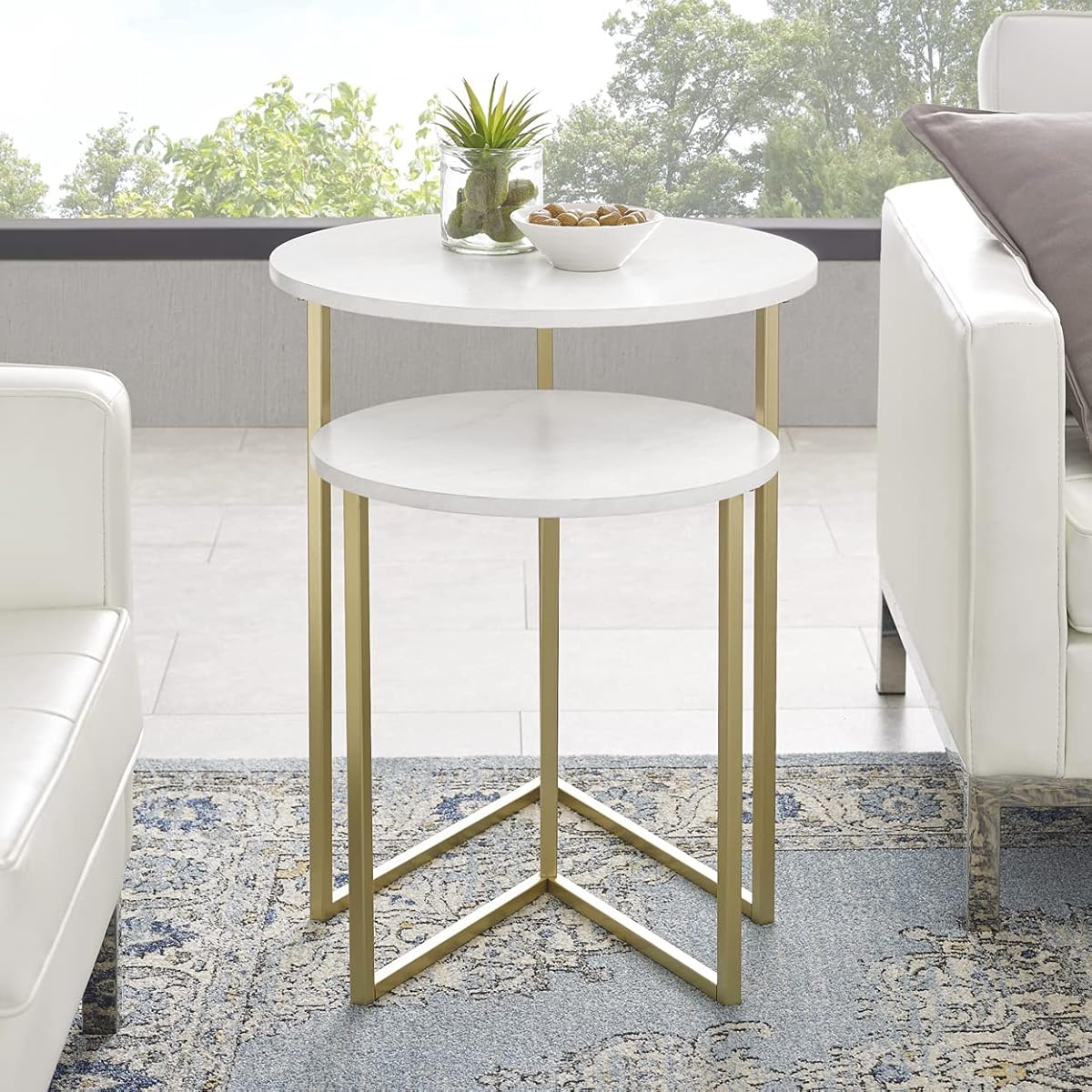 Modern nesting table with gold frame and marble texture top placed in living room β front angle view