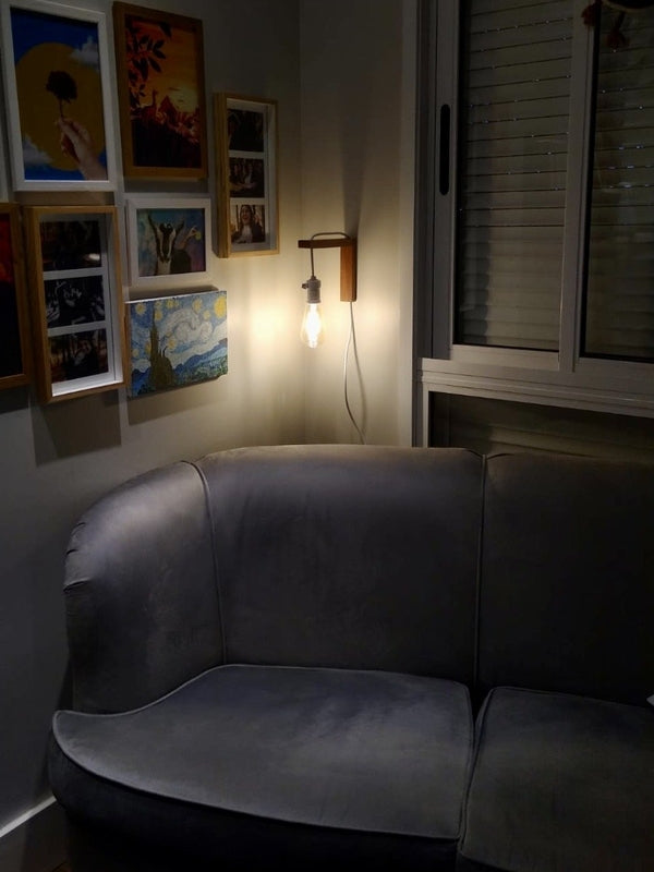 Elegant mounted wooden lamp illuminating bedside area