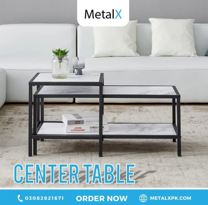 Compact nesting tables stacked together to save floor space in a small Pakistani apartment living room.