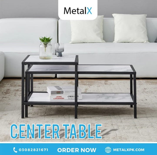 Compact nesting tables stacked together to save floor space in a small Pakistani apartment living room.