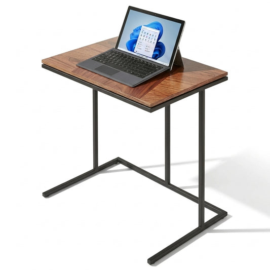 A compact square desk with a brown wood-grain top and a black metal frame, shown with a laptop on a white background.