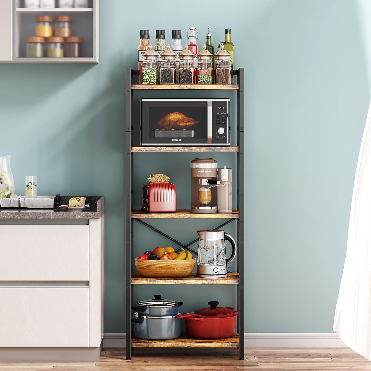Kitchen shelf with appliances and items against a light blue wall.