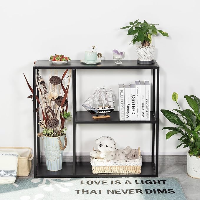 Black metal shelf with decorative items against a white wall