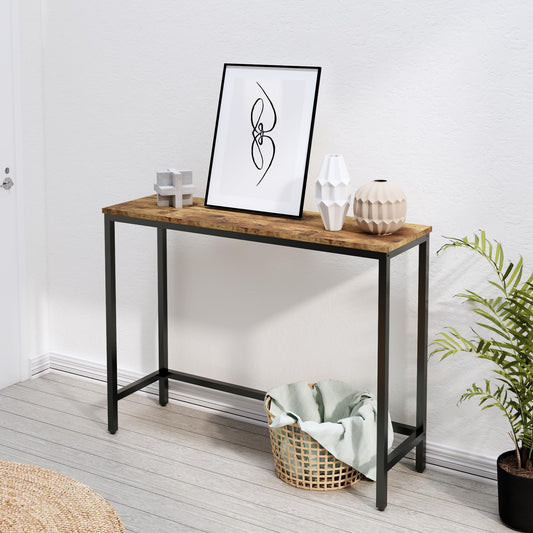 Wooden console table with decorative items against a white wall