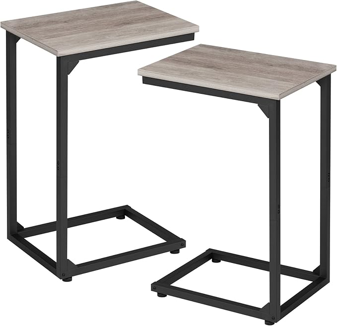 Two small tables with wooden tops and black metal frames on a white background