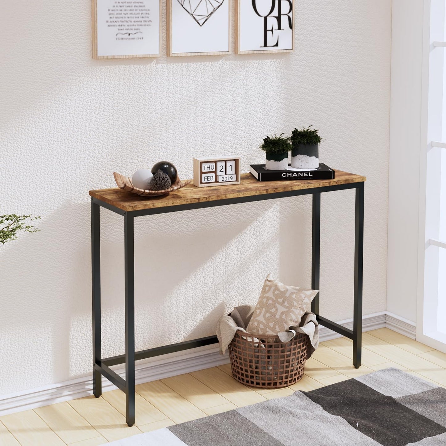 Console table with decorative items in a room with framed art on the wall.