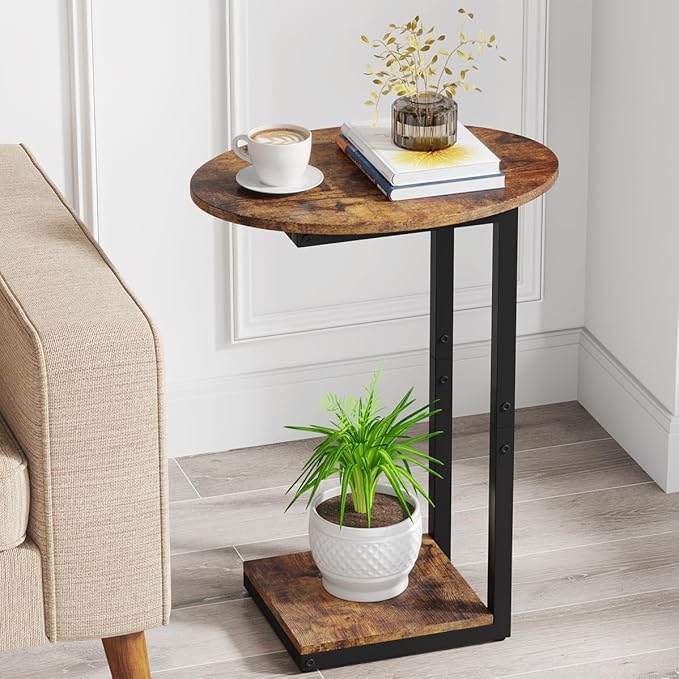 Small round wooden side table with black metal legs next to a beige sofa.