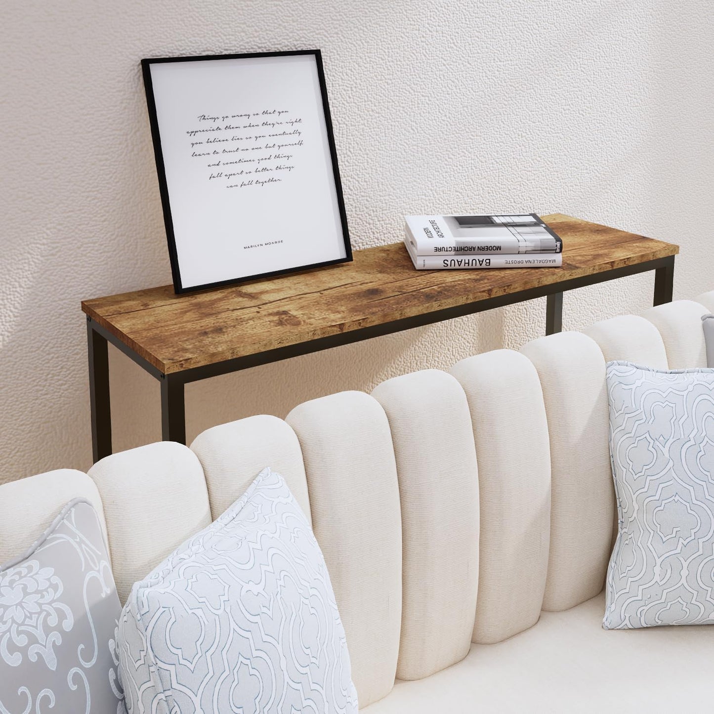 Wooden console table with decor items against a white wall